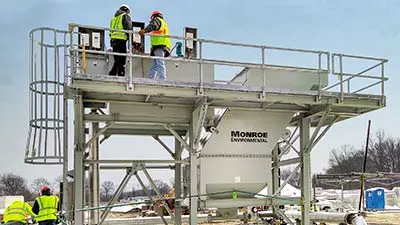 Installation of Vertical Plate Lamella Clarifier for disc filter backwash with chemical mix tanks, access platform, ladder, and support structure.